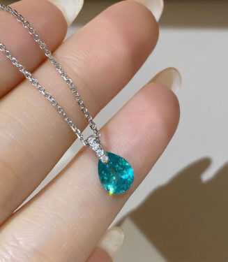 hand held close-up of Rhodium plated Minimalist Sterling Silver Pear-Shaped Paraiba Necklace