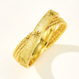 Stacked sterling silver rings with starburst engravings and textured bands, perfect for elegant everyday wear.