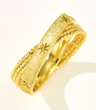 Stacked sterling silver rings with starburst engravings and textured bands, perfect for elegant everyday wear.