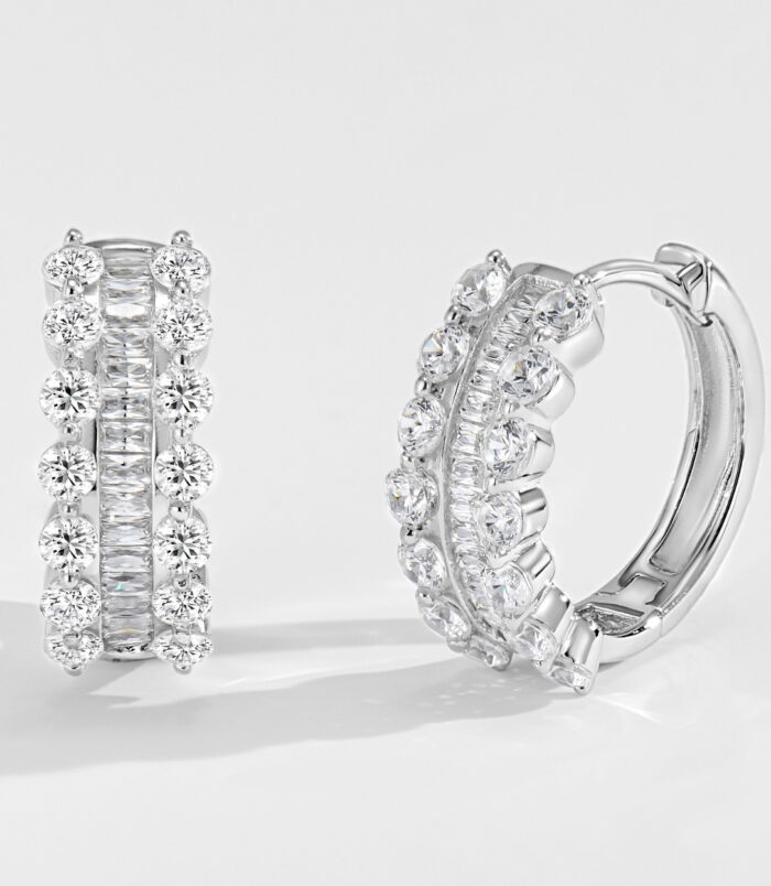 Sterling Silver Cubic Zirconia Huggie Hoop Earrings Sterling silver huggie hoop earrings with alternating round and baguette-cut cubic zirconia stones, polished finish.