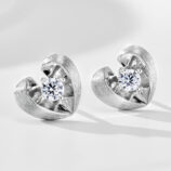Sterling silver heart-shaped stud earrings with a brushed rhodium-plated finish, featuring a round clear cubic zirconia center stone.