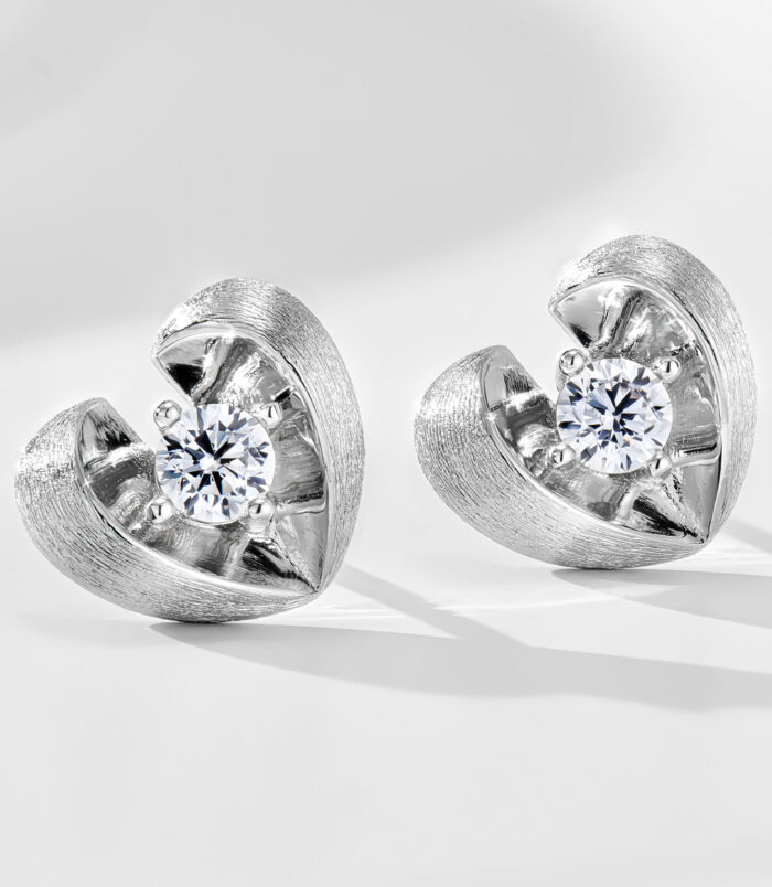 Sterling Silver Brushed Rhodium-Plated Heart Stud Earrings Sterling silver heart-shaped stud earrings with a brushed rhodium-plated finish, featuring a round clear cubic zirconia center stone.