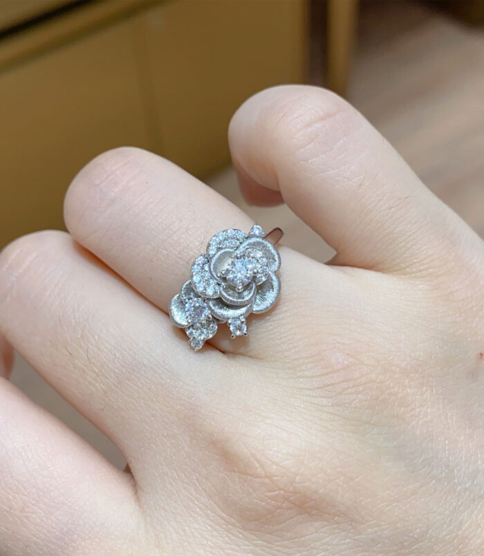 Romantic Rose Design Sterling Silver Ring worn on a model's finger