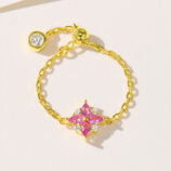 Exquisite sterling silver ring featuring a vibrant pink gemstone centerpiece surrounded by sparkling cubic zirconia, set on a delicate gold-plated chain for a touch of luxury.