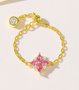 Exquisite sterling silver ring featuring a vibrant pink gemstone centerpiece surrounded by sparkling cubic zirconia, set on a delicate gold-plated chain for a touch of luxury.