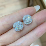 hand held close-up of trendy sterling silver Sugar-shape stud earrings