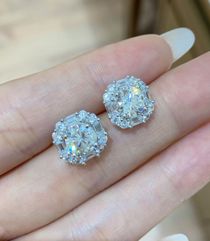 hand held close-up of trendy sterling silver Sugar-shape stud earrings