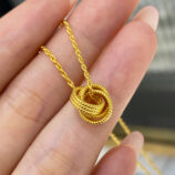handheld close-up of Modern Gold-Plated Sterling Silver Knot Pendant Necklace