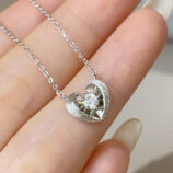 hand held close-up of Rhodium plated 925 Sterling Silver Brushed Heart Necklace
