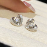 Sterling Silver Brushed Rhodium-Plated Heart Stud Earrings on a jewelry box