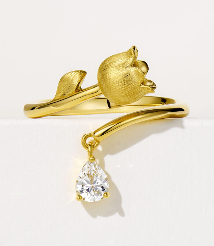 Elegant sterling silver ring with a delicate lily of the valley design, featuring a polished finish and sparkling cubic zirconia accents, symbolizing purity and happiness.