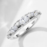 Single 925 sterling silver eternity band from a stackable set, featuring a continuous row of round brilliant-cut cubic zirconia stones set in a polished 925 sterling silver band, creating a sleek and minimalist look perfect for everyday wear or stacking with other rings.