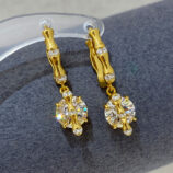 Sterling silver with bamboo-shaped zirconia Huggie Hoop Earrings display on a jewelry stand