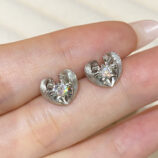 hand held close up of Sterling Silver Brushed Gold-Plated Heart Stud Earrings