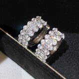 close up of Sterling Silver Cubic Zirconia Huggie Hoop Earrings on a jewelry box
