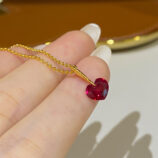 hand held close-up of Charming Sterling Silver Heart-Shaped Red Zirconia Stone Necklace