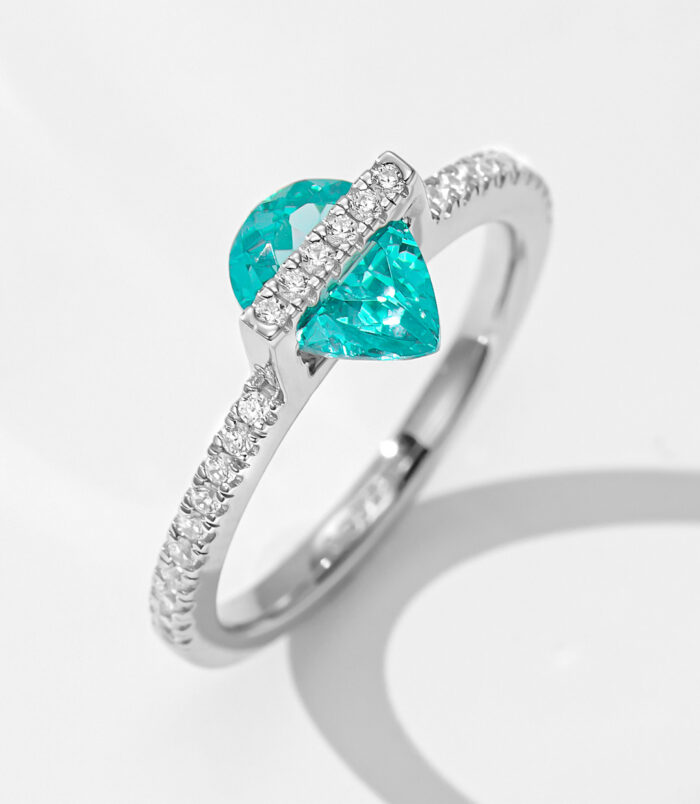 Pear-Shaped Paraiba Tourmaline Sterling Silver Ring with zirconia Accents A striking sterling silver ring featuring a pear-shaped paraiba tourmaline as the centerpiece, complemented by sparkling diamond accents along the band.