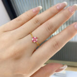 Pink Gemstone Sterling Silver ring with Zircon Accents worn on a model's finger