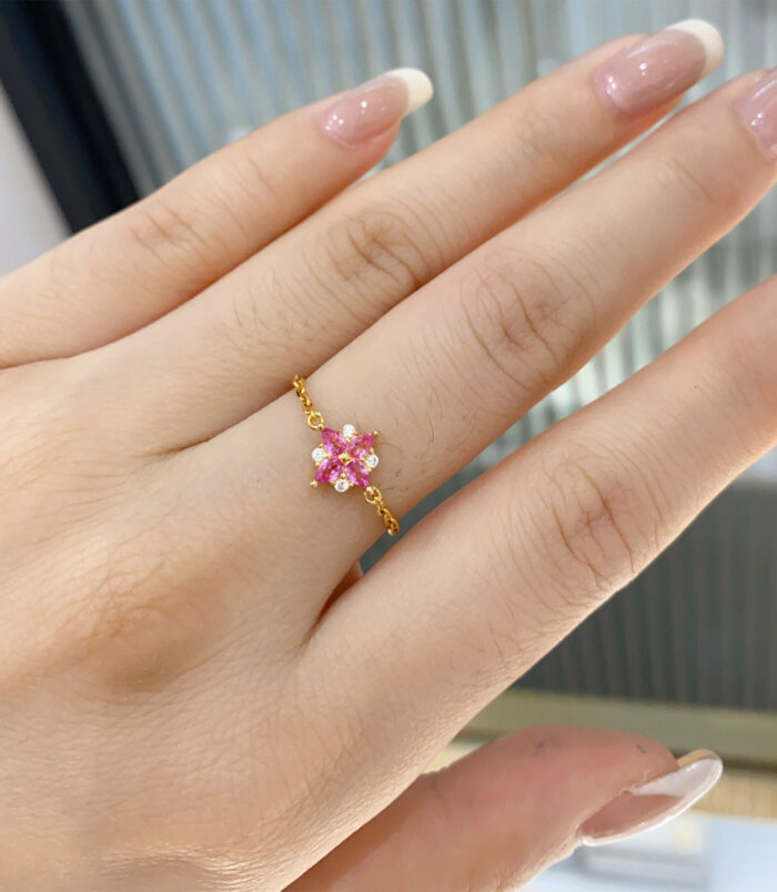 Pink Gemstone Sterling Silver ring with Zircon Accents worn on a model's finger