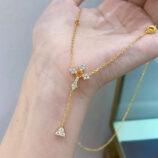 hand held close-up of Gold-Plated Sterling Silver Cross Y-Necklace