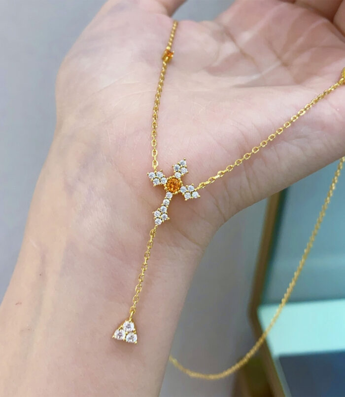 hand held close-up of Gold-Plated Sterling Silver Cross Y-Necklace