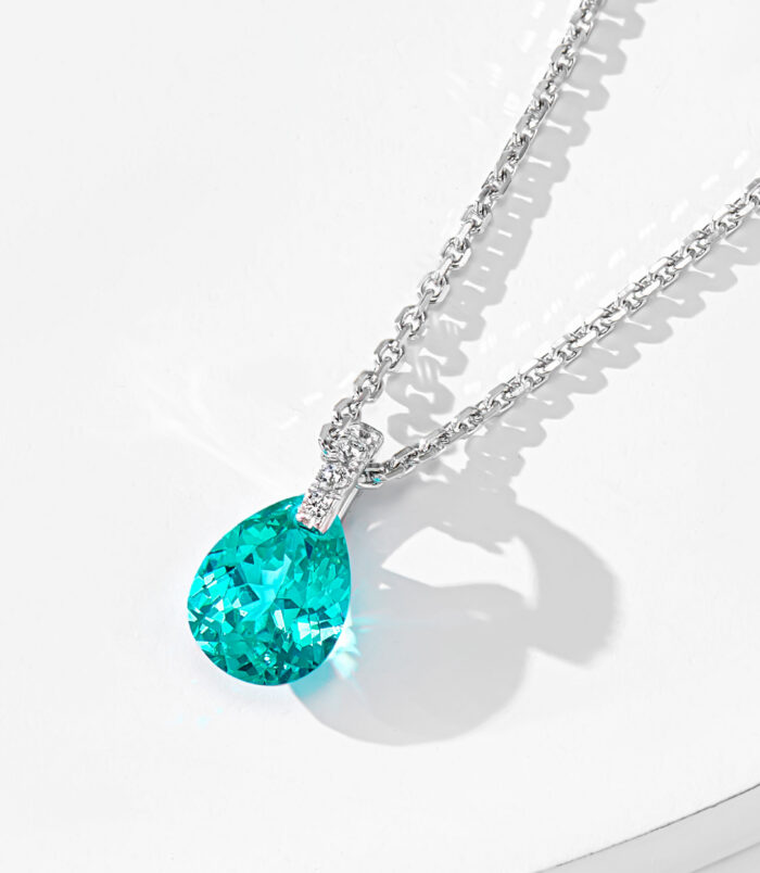 side view close-up of Rhodium plated Minimalist Sterling Silver Pear-Shaped Paraiba Necklace