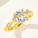 18K gold-plated sterling silver ring with a large round-cut zircon stone and small diamond accents, presenting an elegant and luxurious look.