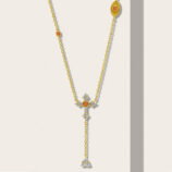 Elegant gold-plated sterling silver Y-necklace featuring a cross-shaped pendant adorned with round white cubic zirconia stones and a central round orange cubic zirconia stone, complemented by a small round orange cubic zirconia stone on the upper chain and a small teardrop-shaped pendant with round white cubic zirconia stones at the bottom, creating a sophisticated and eye-catching look perfect for adding a touch of elegance to any outfit.