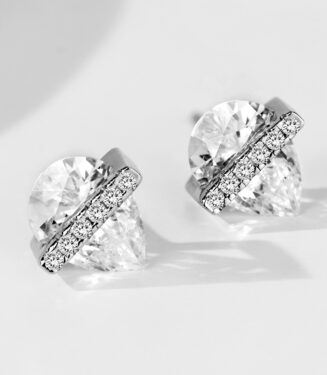 Sterling silver stud earrings with a pear cut cubic zirconia center stone and a horizontal bar of smaller stones.