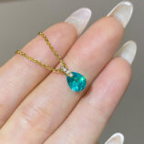 hand held close-up of gold plated Minimalist Sterling Silver Pear-Shaped Paraiba Necklace