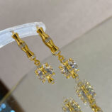 Sterling silver with bamboo-shaped zirconia Huggie Hoop Earrings reflected beautifully on a mirror