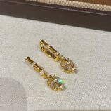 Sterling silver with bamboo-shaped zirconia Huggie Hoop Earrings displayed in a jewelry box