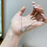 hand held close-up of Sterling silver sugar cube zircon necklace