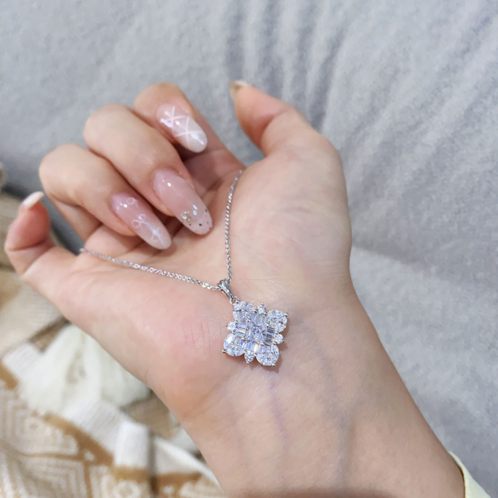 hand held close-up of Dazzling Sterling Silver Snowflake Pendant Necklace