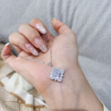 hand held close-up of Dazzling Sterling Silver Snowflake Pendant Necklace