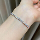 925 silver Rhodium plated zirconia and red string bracelet on a wrist