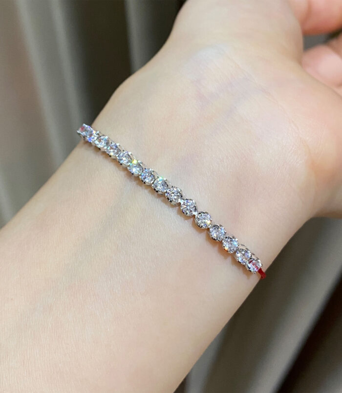 925 silver Rhodium plated zirconia and red string bracelet on a wrist