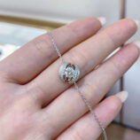 handheld close-up of Rhodium plated 925 silver bracelet, highlighting its unique design like a calla lily