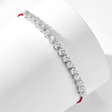 side view of Rhodium plated 925 silver bracelet with cubic zirconia stones and a red string