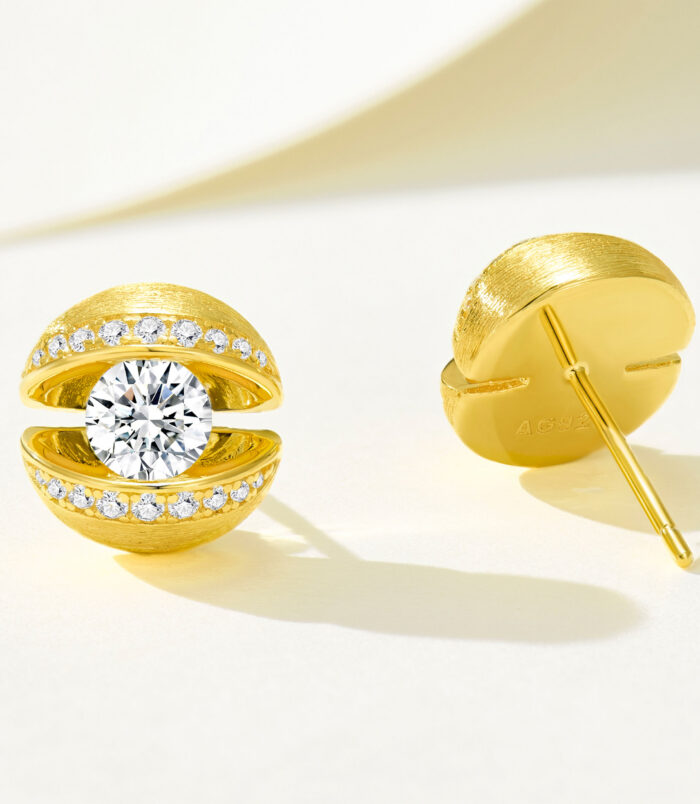 Gold-plated silver stud earrings with a central round cubic zirconia and halo of small stones, hypoallergenic design for women