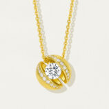 Stylish gold-plated sterling silver pendant necklace featuring a round brilliant-cut white cubic zirconia stone at the center, surrounded by smaller round brilliant-cut white cubic zirconia stones set in a sleek and modern open-circle design, creating a sophisticated and eye-catching look perfect for adding a touch of glamour to any outfit.