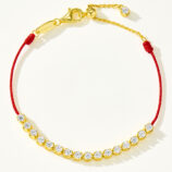 Full view of gold plated 925 silver bracelet with cubic zirconia stones and a red string