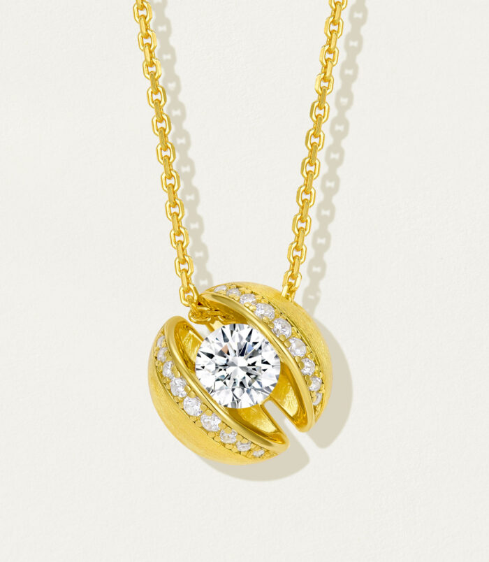 Stylish gold-plated sterling silver pendant necklace featuring a round brilliant-cut white cubic zirconia stone at the center, surrounded by smaller round brilliant-cut white cubic zirconia stones set in a sleek and modern open-circle design, creating a sophisticated and eye-catching look perfect for adding a touch of glamour to any outfit.