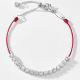Full view of Rhodium plated 925 silver bracelet with cubic zirconia stones and a red string