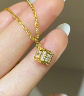 hand held close-up details of Sterling Silver Rubik's Cube Necklace