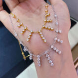 hand held close up of gold plated Sterling silver tassel necklace