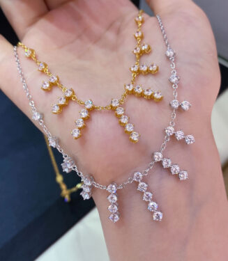 hand held close up of gold plated Sterling silver tassel necklace